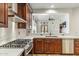 Open kitchen showcasing stainless appliances and wood cabinets at 7111 E Sienna Bouquet Pl, Scottsdale, AZ 85266
