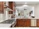 This chef's kitchen features stainless appliances, custom cabinets, and a serving area to the living room at 7111 E Sienna Bouquet Pl, Scottsdale, AZ 85266