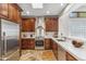 Well-lit kitchen boasting stainless steel appliances, custom cabinetry, and ample counter space at 7111 E Sienna Bouquet Pl, Scottsdale, AZ 85266