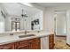 Modern kitchen showcasing stainless appliances and wood cabinets open to the living room at 7111 E Sienna Bouquet Pl, Scottsdale, AZ 85266