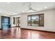 Bright living room featuring hardwood floors, a ceiling fan, and access to the backyard at 7111 E Sienna Bouquet Pl, Scottsdale, AZ 85266