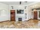 Cozy living room with a fireplace, a TV, and wood accents at 7111 E Sienna Bouquet Pl, Scottsdale, AZ 85266