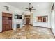 Spacious living area with a fireplace and a view of the kitchen and front entrance at 7111 E Sienna Bouquet Pl, Scottsdale, AZ 85266