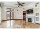 Open-concept living space with a fireplace, backyard access, and custom cabinetry at 7111 E Sienna Bouquet Pl, Scottsdale, AZ 85266