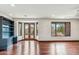 Spacious living room with wood floors, recessed lighting, and views of backyard oasis at 7111 E Sienna Bouquet Pl, Scottsdale, AZ 85266