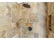 Modern shower featuring a rainfall shower head, stone tile surround, and a built-in alcove at 7111 E Sienna Bouquet Pl, Scottsdale, AZ 85266