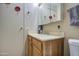 Bathroom featuring wood cabinets, updated sink, and decor providing space for cleaning and storage at 7408 E Bosaga Way, Mesa, AZ 85208