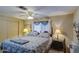 Comfortable bedroom with a ceiling fan, window, and a bed with patterned bedding at 7408 E Bosaga Way, Mesa, AZ 85208