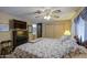 Comfortable bedroom with a ceiling fan, a bed with patterned bedding, and storage at 7408 E Bosaga Way, Mesa, AZ 85208