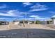 Well-maintained home featuring a wide driveway, covered parking, and low-maintenance yard at 7408 E Bosaga Way, Mesa, AZ 85208
