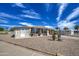 Single-story home boasting desert landscaping, a covered carport, and a peaceful setting at 7408 E Bosaga Way, Mesa, AZ 85208