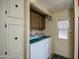 Laundry room featuring white washer and dryer units plus a laundry sink for washing clothes at 7408 E Bosaga Way, Mesa, AZ 85208