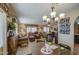 Cozy living room featuring comfortable seating, wood accents, and a charming chandelier at 7408 E Bosaga Way, Mesa, AZ 85208