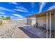 Back patio featuring a gravel ground and lawn space for an outdoor area to relax or cook out at 7408 E Bosaga Way, Mesa, AZ 85208