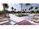 Resort-style pool area with lounge chairs, tables, and beautiful palm trees surrounding the pool at 8024 E Paloma Ave, Mesa, AZ 85212