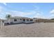 This backyard provides a spacious gravel area and covered patio at 8064 E Madero Ave, Mesa, AZ 85209