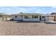 The backyard features a gravel area and a covered patio at 8064 E Madero Ave, Mesa, AZ 85209