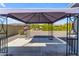Backyard covered patio with concrete slab and decorative rocks, perfect for outdoor entertaining and relaxation at 8064 E Madero Ave, Mesa, AZ 85209