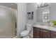 This bathroom features a shower with glass doors, modern vanity, and neutral-colored walls at 8064 E Madero Ave, Mesa, AZ 85209