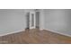 This bedroom has wood flooring, neutral walls, and a mirrored closet door at 8064 E Madero Ave, Mesa, AZ 85209