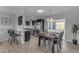 Dining area featuring modern lighting, seating for four, and convenient access to the kitchen at 8064 E Madero Ave, Mesa, AZ 85209