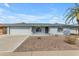 Charming single-story home with white painted brick and beautiful desert landscaping at 8064 E Madero Ave, Mesa, AZ 85209