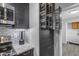 Modern kitchen featuring stainless steel appliances and dark wood cabinetry with functional pull out drawers at 8064 E Madero Ave, Mesa, AZ 85209