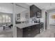 Modern kitchen featuring stainless steel appliances, a breakfast bar, and sleek cabinetry at 8064 E Madero Ave, Mesa, AZ 85209
