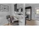Stylish kitchen with stainless steel appliances, granite countertops, and a breakfast bar with leather barstools at 8064 E Madero Ave, Mesa, AZ 85209