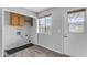 Functional laundry room with a window, storage cabinet, and hookups at 8064 E Madero Ave, Mesa, AZ 85209