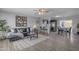 Open-concept living area with hardwood floors, modern decor, and seamless flow to dining and kitchen at 8064 E Madero Ave, Mesa, AZ 85209