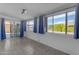 This bright sunroom includes large windows, tile flooring, and access to the backyard at 8064 E Madero Ave, Mesa, AZ 85209