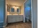 Bathroom featuring double sinks, updated fixtures and tile floors, leading to a toilet and shower at 8154 W Greer Ave, Peoria, AZ 85345