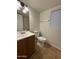 Bathroom with wood vanity, toilet and combination shower and tub at 8154 W Greer Ave, Peoria, AZ 85345