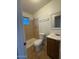 Well-lit bathroom with a toilet, vanity, and shower with tiled walls at 8154 W Greer Ave, Peoria, AZ 85345