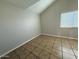This spacious bedroom offers a window and tile flooring, creating a stylish and comfortable space at 8154 W Greer Ave, Peoria, AZ 85345