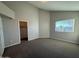 A bright bedroom with a window and an open closet at 8154 W Greer Ave, Peoria, AZ 85345