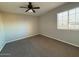 Neutral bedroom featuring a ceiling fan, window with blinds, and carpet flooring at 8154 W Greer Ave, Peoria, AZ 85345
