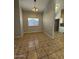 Dining area with tile flooring, a modern light fixture, and a window at 8154 W Greer Ave, Peoria, AZ 85345