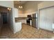 Kitchen with white cabinets, stainless steel appliances, and tile floors at 8154 W Greer Ave, Peoria, AZ 85345