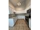 Well-lit kitchen features white cabinets, granite countertops, and stainless steel appliances at 8154 W Greer Ave, Peoria, AZ 85345