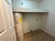 Functional laundry area with water heater, tile floors, and overhead shelf at 8154 W Greer Ave, Peoria, AZ 85345