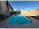 A fenced pool with a large patio area behind a desert home, providing ample space for outdoor enjoyment at 8154 W Greer Ave, Peoria, AZ 85345