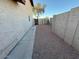 Side yard area with gravel, block wall, and gate access to the backyard at 8154 W Greer Ave, Peoria, AZ 85345