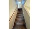 Carpeted staircase with wooden handrail leads to the upper level of the home at 8154 W Greer Ave, Peoria, AZ 85345