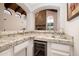 Wet bar features granite countertops, a wine fridge, and a sink at 8155 E Juan Tabo Rd, Scottsdale, AZ 85255
