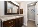 Bathroom featuring a wooden vanity with granite countertop and stylish light fixture at 8155 E Juan Tabo Rd, Scottsdale, AZ 85255