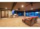 Covered patio with stainless steel grill, stone countertop, ceiling fans, and lounge area at 8155 E Juan Tabo Rd, Scottsdale, AZ 85255