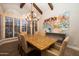 Dining area with a decorative table, large windows with shutters, and chandelier at 8155 E Juan Tabo Rd, Scottsdale, AZ 85255