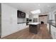 Large kitchen featuring stainless steel appliances, white cabinetry, and wood-look tile flooring at 8155 E Juan Tabo Rd, Scottsdale, AZ 85255